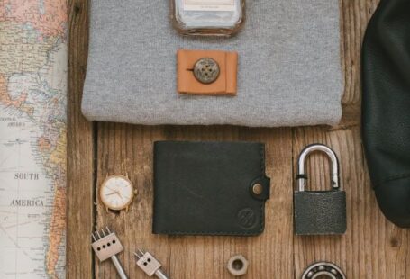 Map - Gray Shirt and Leather Wallet on Wooden Surface