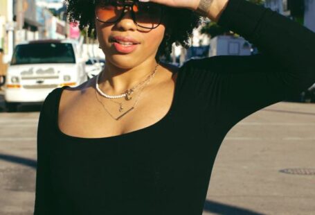 Shading - A woman in jeans and a black top is standing on the street