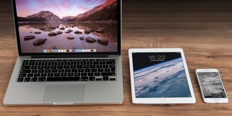 Digital Technology - Macbook Pro Beside White Ipad