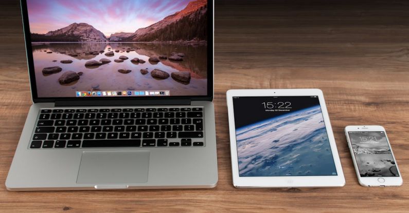 Digital Technology - Macbook Pro Beside White Ipad