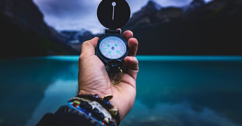 Navigate - Person Holding A Compass