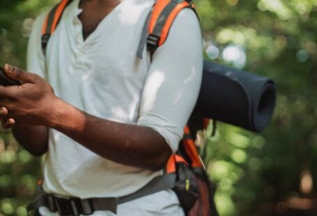 GPS Device - Crop hiker with smartphone in forest