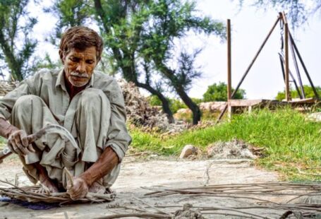 Survival Navigation Skills - Elderly Man Working with Wooden Sticks