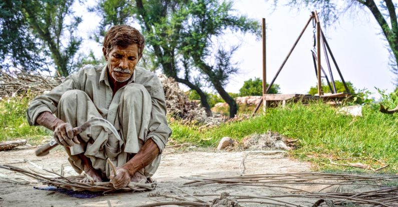 Survival Navigation Skills - Elderly Man Working with Wooden Sticks