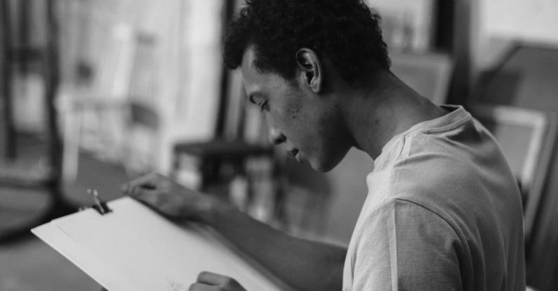 Field Sketching - Grayscale Photo Of A Man Sketching On White Cardboard