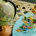 Geographic Education - Globe and a Flat World Map With Country Flag Markers