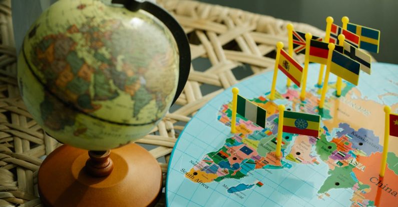 Geographic Education - Globe and a Flat World Map With Country Flag Markers