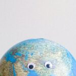 Cartography - Sphere shaped miniature of Earth with googly eyes