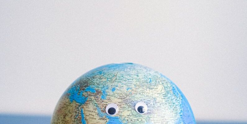 Cartography - Sphere shaped miniature of Earth with googly eyes