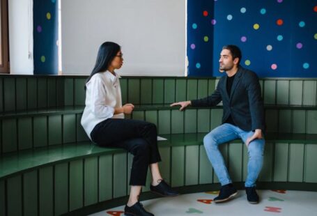 Educators - Man and a Woman Having a Conversation inside a Classroom