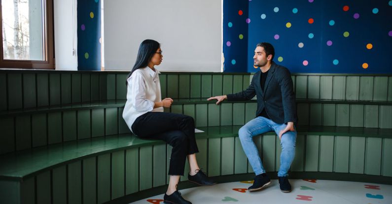 Educators - Man and a Woman Having a Conversation inside a Classroom